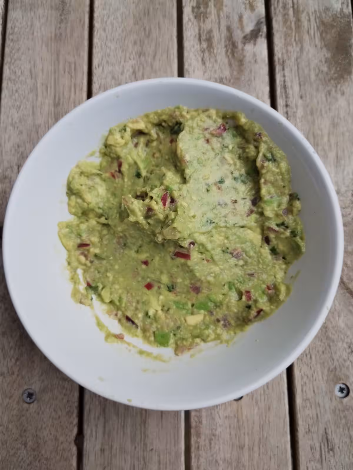 Mélange onctueux de l'avocat avec les oignons rouges, le jus de citron et la coriandre