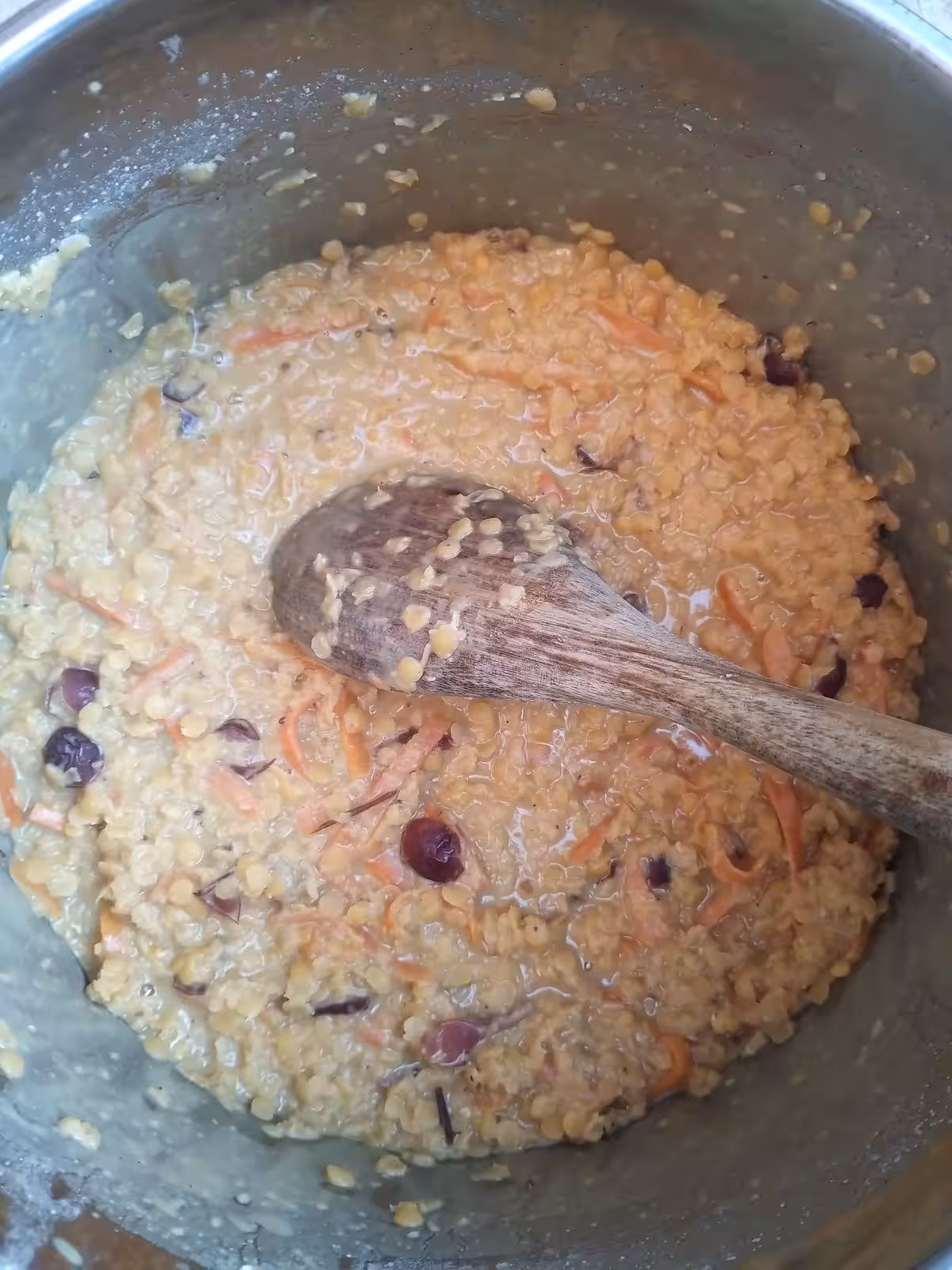 Add maple syrup to pre-cooked lentils, carrots, vegetable milk, raisins and spices.